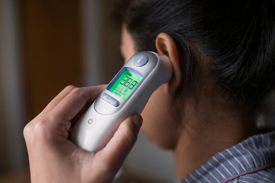Woman checking her temperature, Sweden