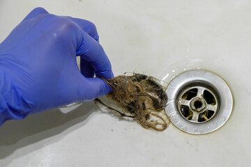 draining the sink in the bathroom with hair