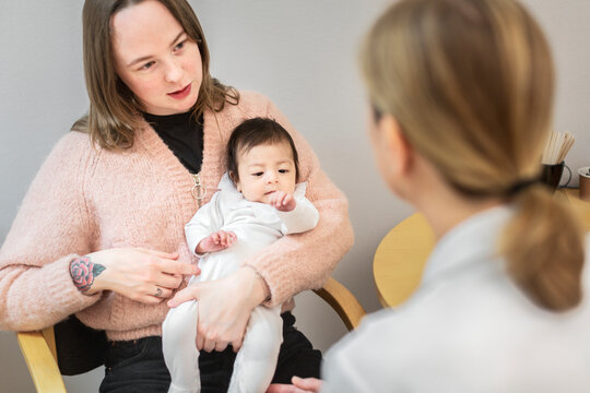 Mother with baby in doctor's office, Sweden