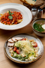 Chicken caesar salad with croutons and grated parmesan, side view, part of a set lunch