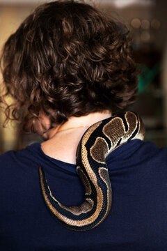 Woman with snake on shoulder, Sweden