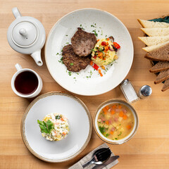 Appetizing lunch a wooden table, variety of european meals