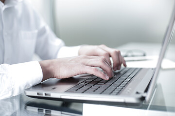 The manager works at the computer in the office