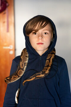 Boy with python on his shoulders, Sweden