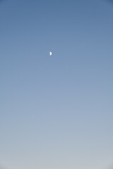
Sunset on the beach with half moon and sand