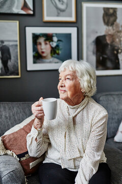 Senior woman holding mug, Sweden