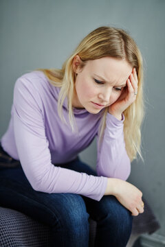 Woman sitting with her head in hands, Sweden