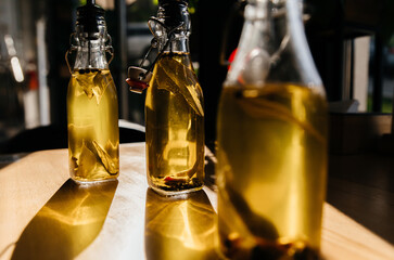yellow edible oil in transparent bottles on the table. Game of light and shadow