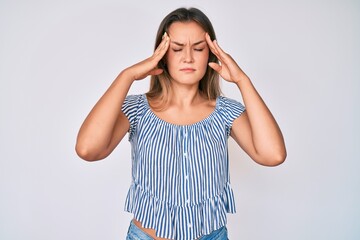 Beautiful caucasian woman wearing casual striped shirt with hand on head, headache because stress. suffering migraine.