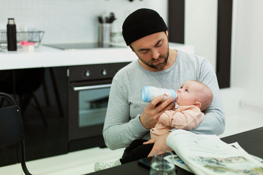 Father feeding baby, Sweden