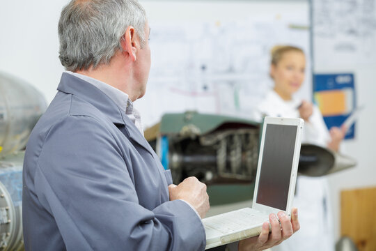 Electronic Technician Man At Repair Shop With Laptop