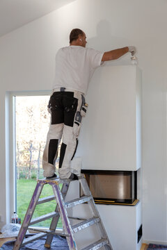 Man installing fireplace, Sweden