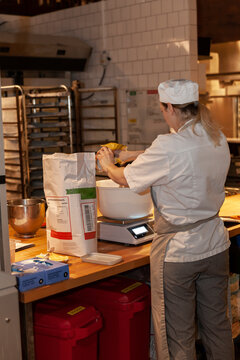 Female baker in commercial bakery, Sweden