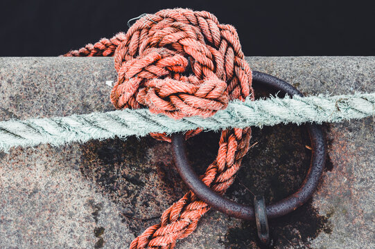 Sailor knots on jetty tied in round metal ring, Sweden