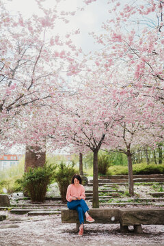Woman sitting on park bench, Sweden