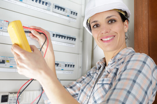 woman using voltage on fuseboard