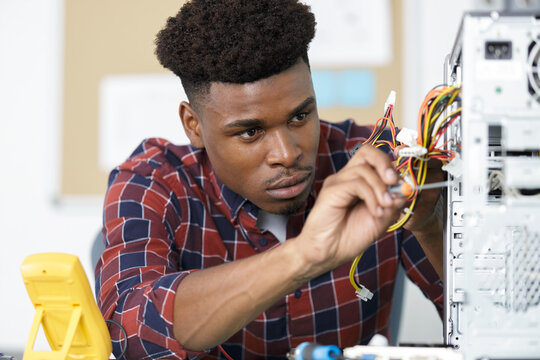 focused computer repair technician at work