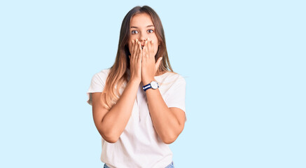 Beautiful caucasian woman wearing casual white tshirt afraid and shocked, surprise and amazed...