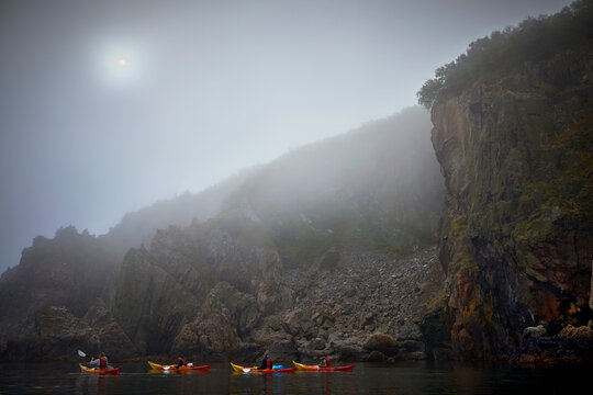 People kayaking in foggy weather, Sweden
