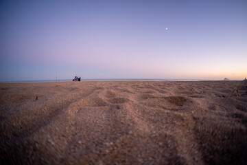 
Landscape of the beach from the sand in autumn at sunset.