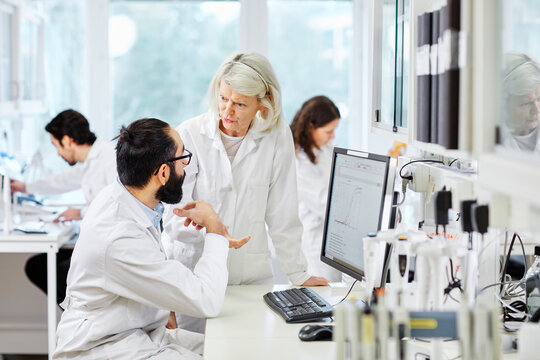 Coworkers talking in laboratory, Sweden