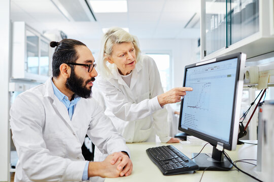 Coworkers talking in laboratory, Sweden