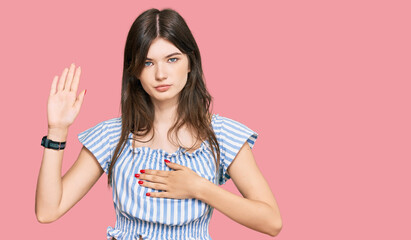 Young beautiful caucasian girl wearing casual clothes swearing with hand on chest and open palm, making a loyalty promise oath