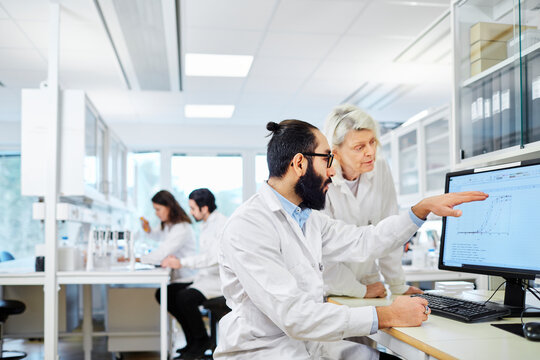 Coworkers talking in laboratory, Sweden