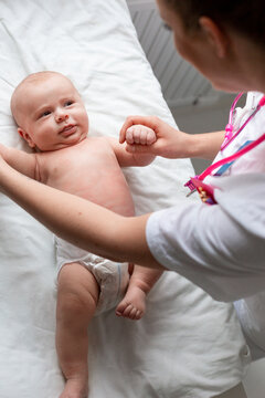 Female doctor examining baby, Sweden