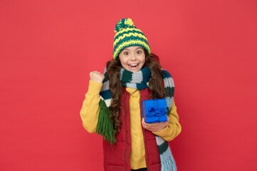 happy childhood. teen girl hold box. knitted clothing style. new year holiday. cheerful child wear warm winter clothes. successful seasonal shopping sales. buy presents and gifts for christmas