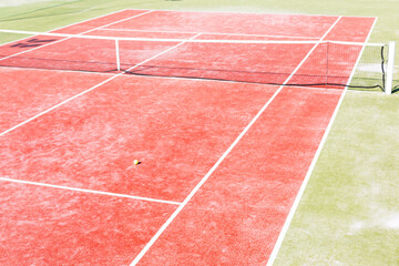 Fototapeta premium High angle view of empty red tennis court on sunny day