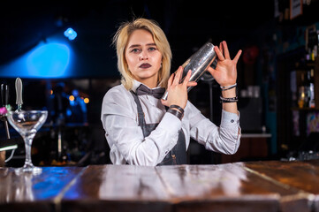 Girl barman makes a cocktail at the pothouse