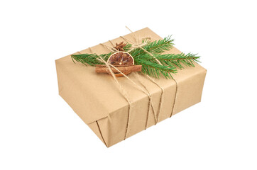 Christmas gift box decorated with fir tree branch and spices isolated on white background.