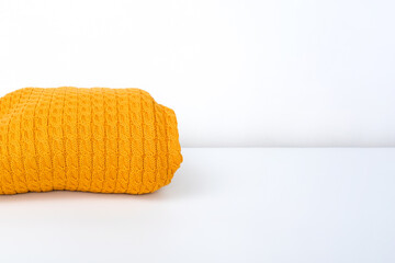 tacked yellow trendy color sweater, pullover on white background, cozy fall and winter knitwear, copy space