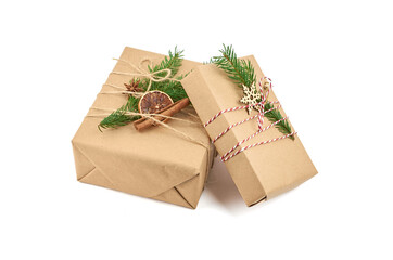 Two christmas gift boxes with fir tree branch and festive decorations isolated on white background