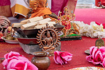 Different traditional accessories for indian wedding ceremony on white background with flowers