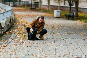 Happy man with labrador in park