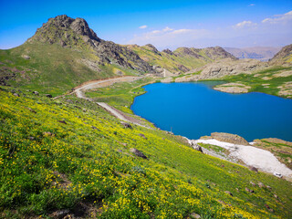 Fototapeta na wymiar View of a lake in mountains. Hakkari cilo sat lakes, snowy mountains and natural scenery 
