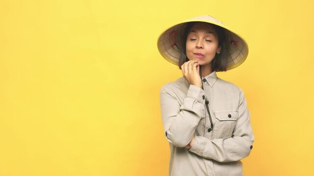 Young latin woman with vietnamite hat  relaxed thinking about something looking at a copy space