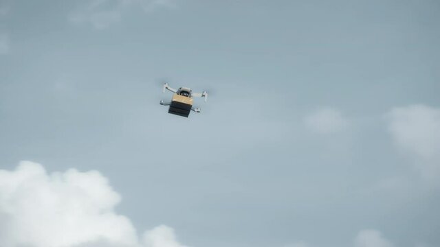 flying on a sky delivery drone with holding a .cardboard parcel