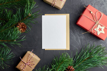 Greeting card mockup with christmas gift boxes and pine tree branches