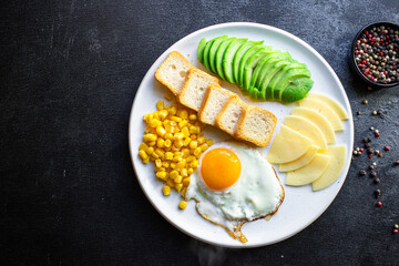 English breakfast fried egg, bread toast, vegetables, corn, cheese and more ready to eat on the table serving healthy meal snack ingredient top view copy space for text food background rustic
