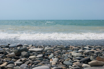 A small storm three or four points at sea, the wave hits the shore with a large pebble. Black Sea, summer vacation vacation beach travel