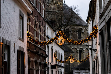 Fototapeta na wymiar Winter Holidays in Europe. Festive Christmas lights on the streets of the night city, soft focus. Christmas in Maastricht, the Netherlands.