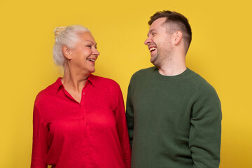 Joyful caucasian mother and son laughing at joke