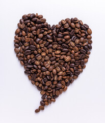 Pointy heart shape made out of coffee beans on a white background
