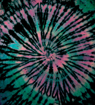 Reverse spiral tie dye in green pink. Hippie tie-dye pattern texture background wallpaper.