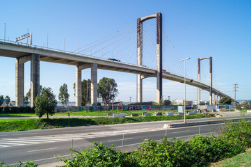 The Fifth Centennial Bridge in Seville is the second tallest structure in the city and allows connecting the highway over the Guadalquivir River (Andalusia, Spain). Modern concrete bridge and cables.