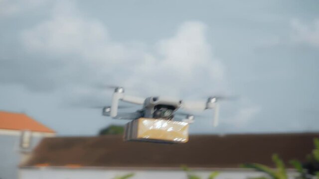 flying on a sky delivery drone with holding a .cardboard parcel