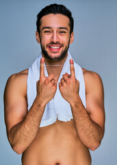 Guy with wide smile with black hair with a beard shows a dental floss  stretched over index fingers. Dental concept